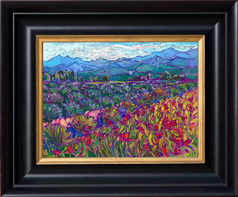 This northwestern oil painting captures rows of cultivated lavender fields and red poppies growing beneath the distant blue coastal mountains. This petite oil painting arrives framed in a plein air frame, ready to hang.