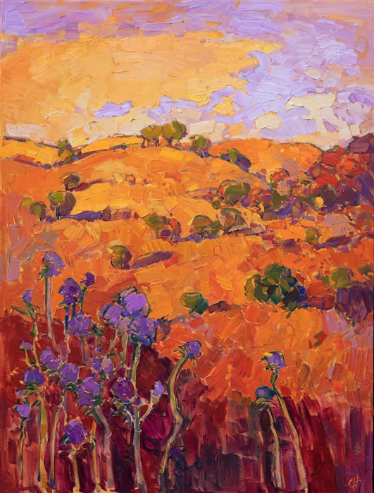 Rich layers of orange paint build up to an exciting depiction of Paso Robles' rolling hills and rounded oak trees. The purple thistles in the foreground stand out in vibrant contrast against the mandarin backdrop of hills. This oil painting was created with juicy, impasto brush strokes and a loose, impressionistic style.</p><p>This painting has been framed in an Open Impressionist frame. These frames are one-of-a-kind, hand carved in the US and hand-gilded with 23kt gold leaf. Read more about the <a href="https://www.erinhanson.com/Blog?p=AboutErinHanson" target="_blank">painting's details here.</a></p><p>Exhibited <a href="https://www.erinhanson.com/Event/ErinHansonTheOrangeShow"><i>The Orange Show</i></a>, The Erin Hanson Gallery, Los Angeles, CA. 2016.