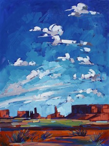 The desert sky over Monument Valley is hugely expansive, a deep ultramarine blue.