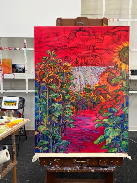 Erin Hanson painting Fields of Sunflowers in the studio