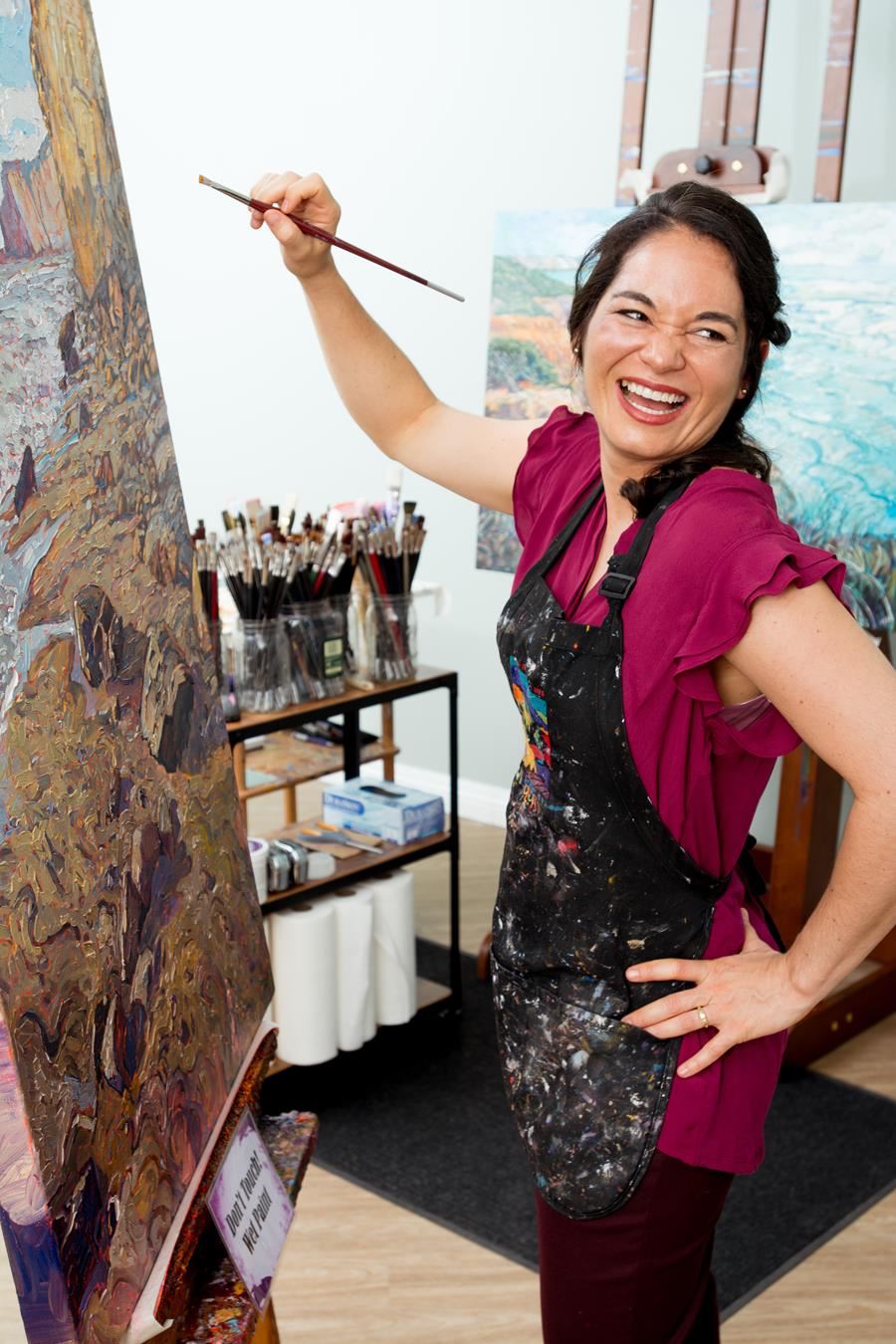 Erin Hanson painting in her studio