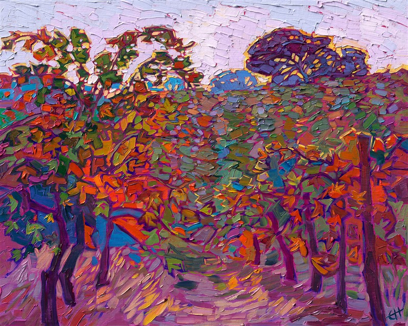An impressionistic flurry of autumn color, this petite oil painting captures the beauty of Paso Robles wine country in the fall. A periwinkle sky glows with hints of sunshine yellow, while the rows of vines glow with subtle color changes ranging from pumpkin orange to royal purple.</p><p>"Autumn Vines" was created on 1/8" linen board. The piece arrives framed in a gold plein air frame, ready to hang.