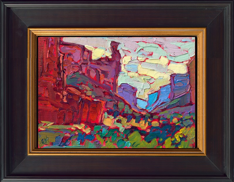 This small canvas captures the grand vista of Canyon de Chelly in Arizona with a few loose, expressive brush strokes. The saturated colors in this petite work create a medley of texture and movement within the piece.</p><p>"Canyon Reds" is an original oil painting on linen board. The piece arrives framed in a wide, custom frame designed to set off the colors in the piece.