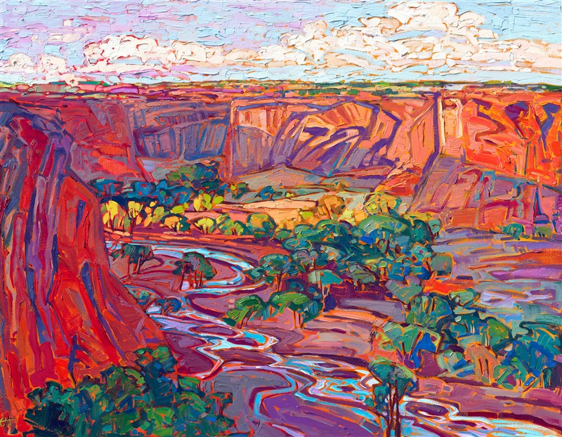 The brilliant hues of dawn illuminate the red rock cliffs of Canyon de Chelly, Arizona. The summer-green cottonwoods gleam with warm yellow light, and the winding stream reflects the blue morning sky above.</p><p>"Canyon de Chelly Dawn" was created on gallery depth linen canvas, and the painting arrives framed in a contemporary gold floater frame, ready to hang.