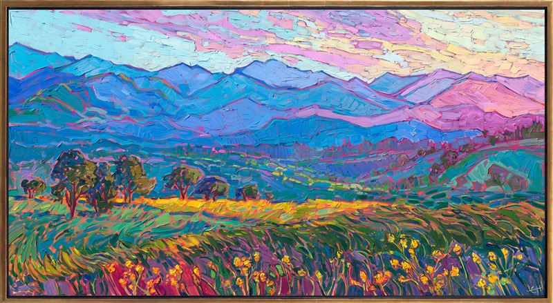 The coastal range bordering the Willamette Valley in Oregon transforms into a luminescent pattern of contrasting colors as the sun sets below the opposing mountain range. Rich hues of ultramarine blue, turquoise, and purple are layering into the fading distance. In the foreground, fields of early summer mustard plants are in bloom.