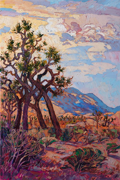 Joshua Tree National Park is a must-visit for anyone who loves the California desert. The joshua tree desert stretches as far as you can see in every direction, intermingled with rounded granite boulders forming unique shapes and cracks for climbers. This painting captures a summer afternoon fading into sunset.</p><p>"Joshua Clouds" was created on 1-1/2" canvas, with the painting continued around the edges. The piece has been framed in a custom-made, gold floater frame.