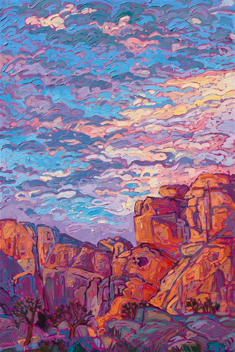 Warm dawn light strikes the curving surfaces of Joshua Tree National Park's famous granite boulders. The sky above is streaked with hues of lavender and orange. Each impressionistic brush stroke conveys the color and drama of the landscape.</p><p>"Joshua Dawns" was created on 1-1/2" canvas, with the painting continued around the edges. The piece arrives framed in a contemporary gold floater frame.