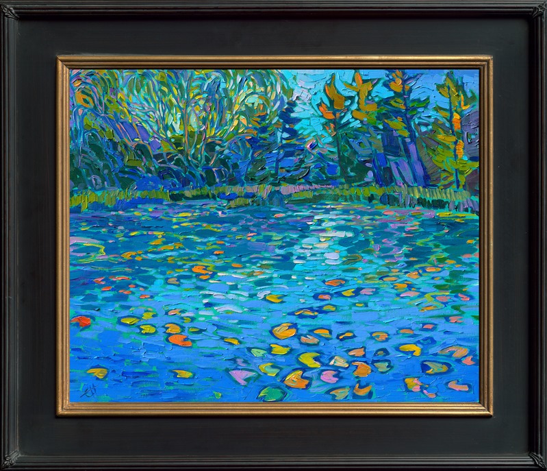 Cool hues of blue are reflected in a calm, tree-lined pond. Lily pads add pops of color to the ultramarine waters. Each impressionist brush stroke conveys a sense of tranquility and gentle movement.</p><p>"Lilies on Blue" was created on fine linen board. The piece arrives framed in a black and gold plein air frame.