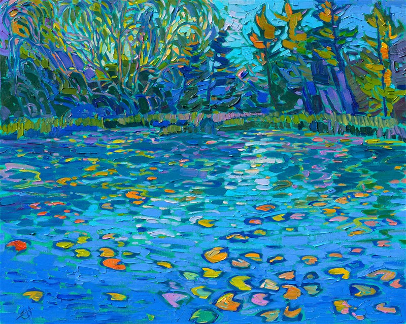 Cool hues of blue are reflected in a calm, tree-lined pond. Lily pads add pops of color to the ultramarine waters. Each impressionist brush stroke conveys a sense of tranquility and gentle movement.</p><p>"Lilies on Blue" was created on fine linen board. The piece arrives framed in a black and gold plein air frame.