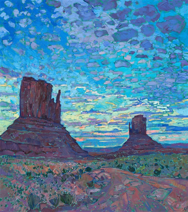 Anyone who has seen a sunset over Monument Valley will never forget it.  As the world slowly darkens and the landscape hushes, the sky celebrates the closing of another day with brilliant hues and cloud formations.  This painting captures that transient moment in time with thick, impasto brush strokes and expressionistic color.

This painting was done on 1-1/2" canvas, with the painting continued around the edges.  It has been framed in a gilded and hand-carved floater frame.

--- 

Monument Valley
<B>F U N   F A C T S</B>

Formed during the Permian period (50 million years before dinosaurs roamed the earth), this patch of land once formed part of a seafloor where sediments and sandstone piled up in layers for millions of years. The Valley is now a sacred place for the Navajo, whose mythology holds that these grand spires contain the spirits of Najavo warriors. Monument Valley is found on the Navajo National Reservation. 

The Valley is also one of the most filmed spots in the history of filmmaking. The valley was hailed "John Wayne country" for appearing in no less than five of his movies. It also served as a backdrop for an iconic scene in Forest Gump. 

"There are certain places in the world that seem like special effects, they don't seem real," said film historian Scott Eyman. "They're too perfect. And the first time you come here, you see it through John Ford's eyes." (Ford is widely regarded as one of the most important and influential film-makers in history.)

--

This painting was a part of the <a href="https://www.erinhanson.com/Event/redrock2018" target=_blank"><i>The Red Rock Show</i></a> in San Diego in 2018.  <a href="https://www.erinhanson.com/Portfolio?col=The_Red_Rock_Show_2018" target="_blank"><u>Click here</u></a> to view the other Red Rock paintings.

