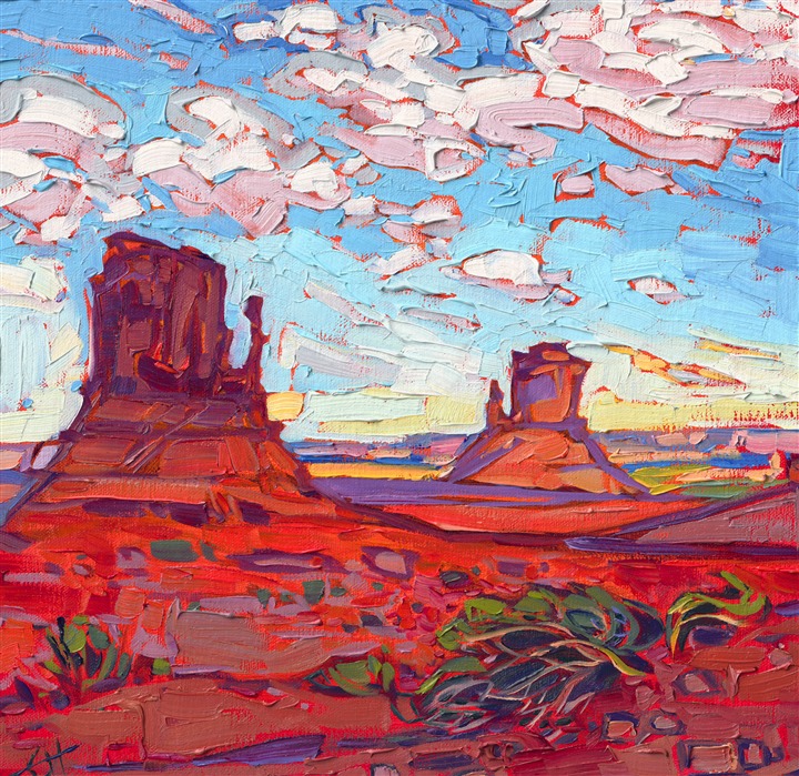 Monument Valley is captured in rich hues of red against a baby blue sky. The brush strokes are thick and impressionistic, alive with color and texture.</p><p>"Monument Clouds" is an original oil painting on linen board. The piece arrives framed in a black and gold plein air frame.