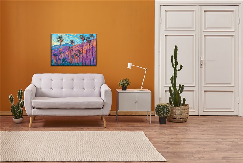 A line of palm trees stands before the San Jacinto mountains in Palm Springs. The steep desert mountains catch the first rays of dawn and turn fiery hues of orange and gold in the morning light. Thick brush strokes of oil paint capture the feeling of movement and vivacity of the scene.</p><p>"Mountain Palms II" is an original oil painting done on stretched canvas. The piece arrives framed in a custom-made, gold floater frame.