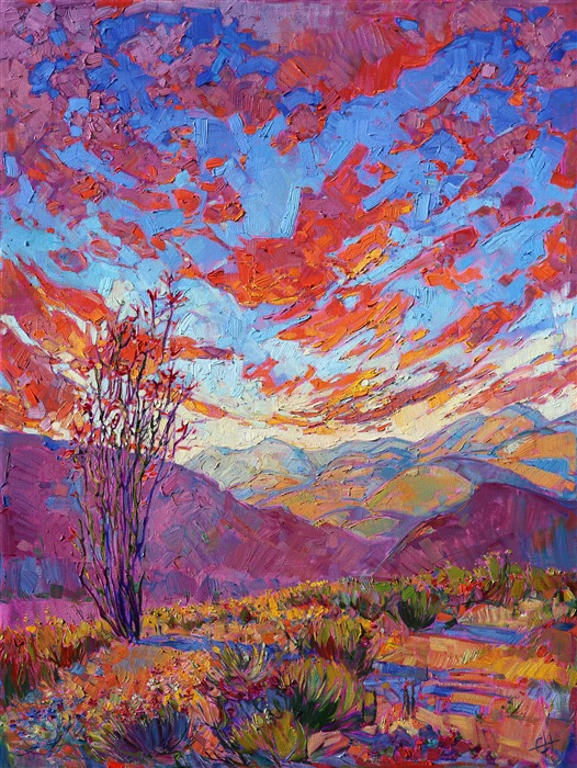 Vivid color and loose brush strokes capture the beauty of a setting sun across the layered mountains of Borrego Springs, California. The tall, graceful ocotillo stands boldly in the foreground, its long limbs blooming with heavy red flowers. The desert in bloom is one of the most beautiful sights in California.