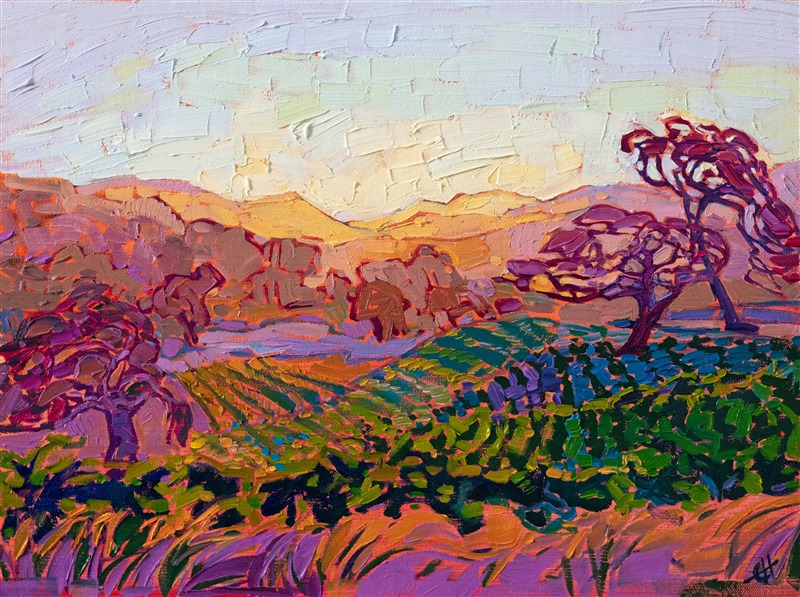 Sloping hills covered in grapevines fade into the distance in this painting of Paso Robles, near the Peachy Canyon tasting room. The early morning light casts a warm yellow hue over the cool purples of shade.</p><p>"Paso Vines" was created on fine linen board, and the piece arrives framed in a gold plein air frame.