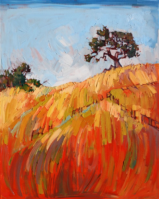 Central California turns a vibrant red-gold as the landscape heats up in summer. The crisp golden grass is a lovely contrast against the green oak trees.