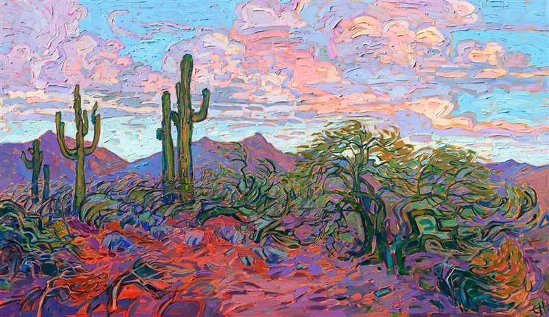 Buttercup-hued clouds drift above this Arizona landscape, and rich purple shadows stretch across the red earth. The impressionist brush strokes and thick and loose, conveying a sense of movement throughout the painting.</p><p>"Saguaro Clouds" was created on gallery-depth canvas, and the painting arrives framed in a contemporary gold floater frame, ready to hang.