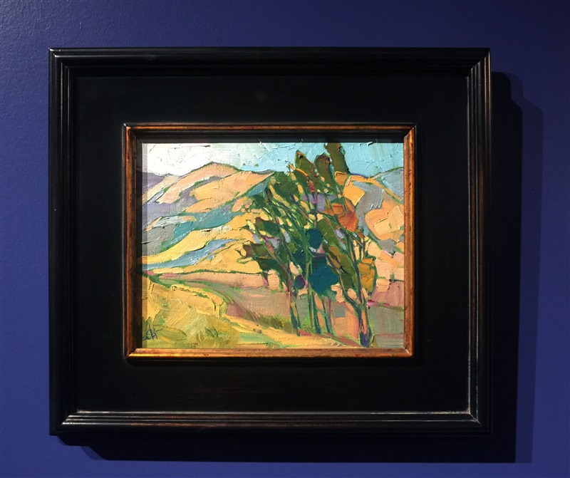A grove of eucalyptus trees stands tall before the distant summer-hued hillsides.  Each brush stroke in this painting is free and expressive, a spontaneous stroke of motion and color.</p><p>This small oil painting arrives framed and ready to hang. The second photograph above shows the painting hanging in gallery spot lighting.