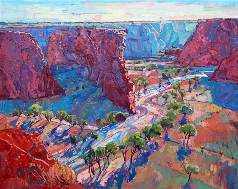 The lush valley floor of Canyon de Chelly is covered in spring green cottonwoods, following the winding river waters. This painting brings the drama and beauty of the red rock desert to your home.</p><p>This large piece arrives framed in a contemporary gold floater frame, ready to hang.