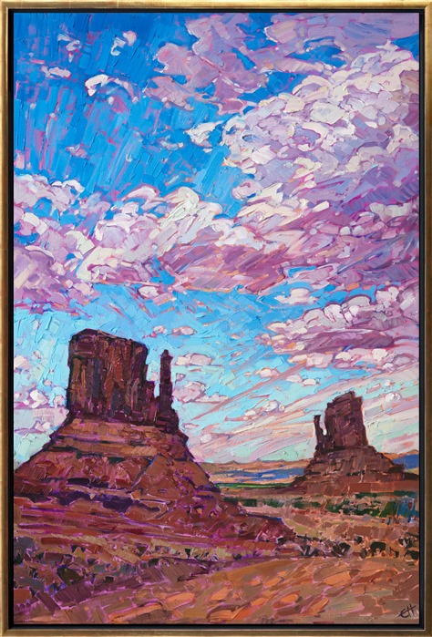 The "Mittens" at Monument Valley are some of the most dramatic buttes on the Colorado Plateau. These amazing red rock formations are most beautiful and sunrise or sunset, when their colors become even more brilliant and saturated. This painting captures the dramatic desertscape with loose, impressionistic brush strokes.</p><p>This painting was created on 1-1/2" canvas, with the painting continued around the edges. The piece has been framed in a carved gold floater frame.