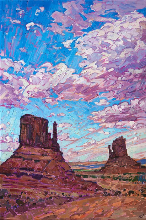 The "Mittens" at Monument Valley are some of the most dramatic buttes on the Colorado Plateau. These amazing red rock formations are most beautiful and sunrise or sunset, when their colors become even more brilliant and saturated. This painting captures the dramatic desertscape with loose, impressionistic brush strokes.</p><p>This painting was created on 1-1/2" canvas, with the painting continued around the edges. The piece has been framed in a carved gold floater frame.
