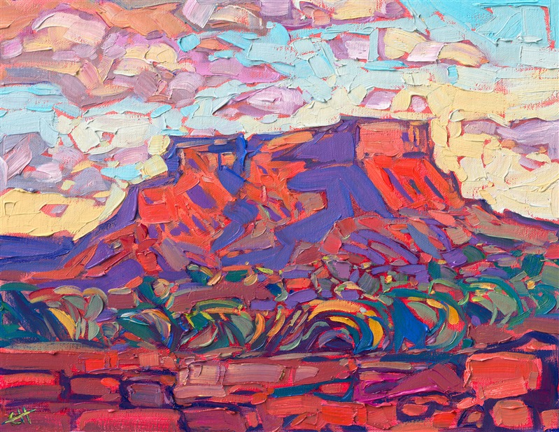 A red rock butte between Monument Valley and Mexican Hat glows with the colors of sunset in the high desert. The pale green sage bushes stand out starkly against the dark red earth. Luscious brush strokes of oil paint carve out the texture of the desert landscape.</p><p>"Utah Butte" is an original oil painting on linen board. The piece arrives framed in a plein air frame.