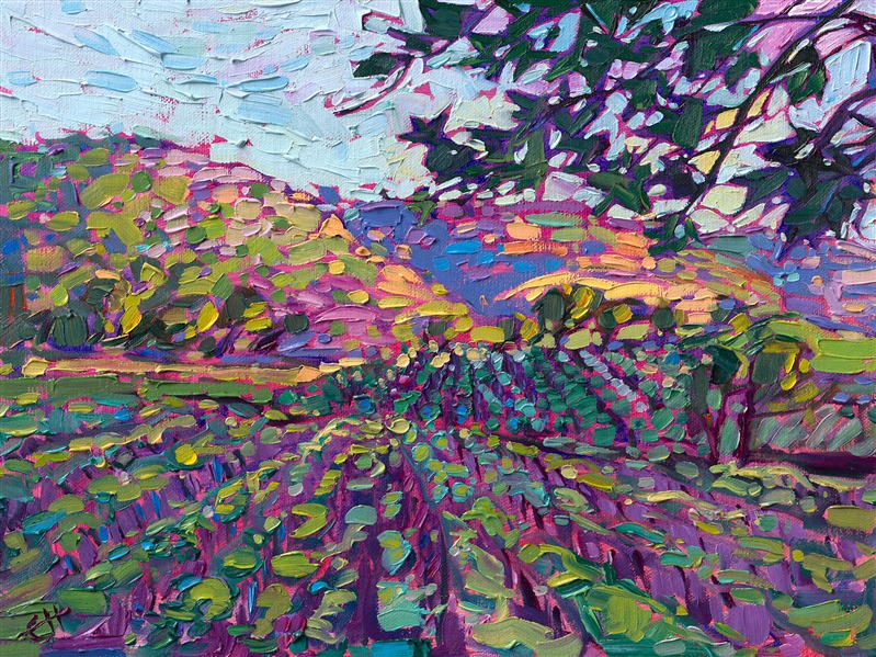 The golden hills of central California wine country catch the light of dawn, glowing with sherbet hues of pink and orange. The vineyards in the foreground lay cool and green in the valley, waiting for dawn to illuminate the fields.</p><p>"Vineyard Dawn" was created on fine linen board, and the piece arrives framed in a classic plein air frame.