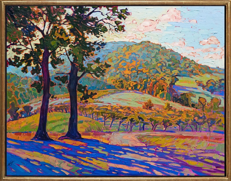The softly rolling hills of Virginia's wine country are captured in soft greens and oranges. The impasto and impressionistic brush strokes add a dimension of motion to the picture, inviting you into the scene.</p><p>"Virginia Vineyards" was created on 1-1/2" canvas, with the painting continued around the edge. The piece arrives framed in a hand-made, closed-corner floater frame finished in warm, 23kt gold leaf.