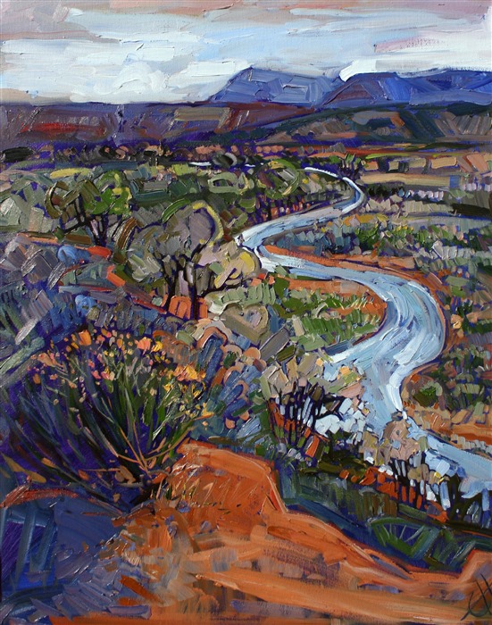 A winding river near Albuquerque, New Mexico, reflects the slate gray sky of an early May morning.