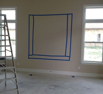 Pre-taping the wall where a painting will be hung
