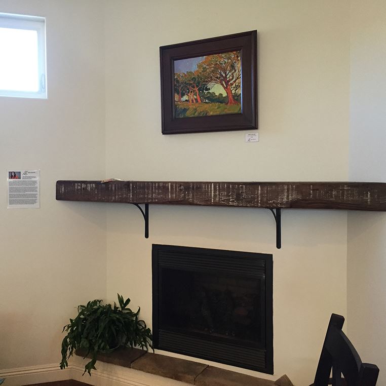 An Erin Hanson painting above a fireplace